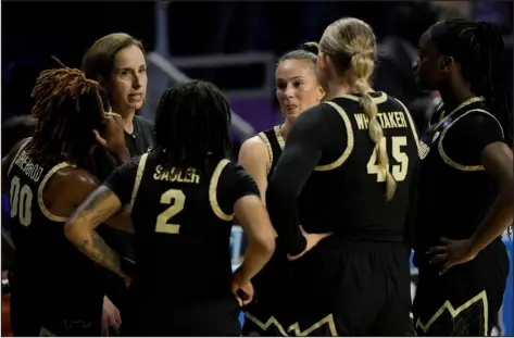  ?? CHARLIE RIEDEL — THE ASSOCIATED PRESS ?? Colorado head coach JR Payne talks to her players during the first half of a second-round NCAA Tournament game against Kansas State in Manhattan, Kan., on Sunday.