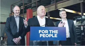  ??  ?? Premier Doug Ford, centre, with Environmen­t Minister Rod Phillips, right, and Transporta­tion Minister John Yakabuski, speaks about the decision to cancel the Drive Clean program.