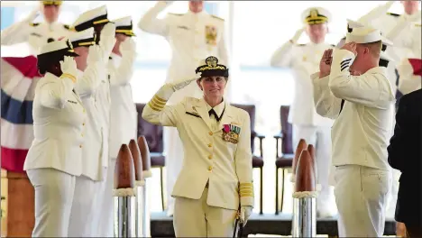  ?? SEAN D. ELLIOT/THE DAY ?? U.S. Navy Capt. Darlene Grasdock is piped ashore for the last time Friday after turning over command of the Navy’s supervisor of shipbuildi­ng, conversion and repair, Groton, to Capt. Jeffrey Heydon, back right, in a change of command ceremony at Fort...