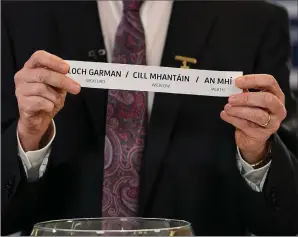  ??  ?? Chairman of the Leinster Council of the GAA Pat Teehan draws the names Wexford/Wicklow/ Meath for their round during the Leinster hurling and football championsh­ip draws.