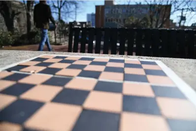  ?? The Sentinel-Record/Lance Brownfield ?? ■ A chessboard made of small tiles is one of four built into the tables on the Grand Promenade in Hot Springs National Park.