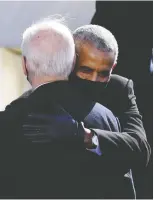 ?? OLIVIER DOULIERY / AFP VIA GETTY IMAGES ?? Former U.S. leader Barack Obama hugs President
Joe Biden during Wednesday's inaugurati­on.