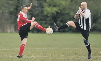  ??  ?? Over-40s League action as John Hogg Funerals (red and white) take on Blakelaw SC last weekend.