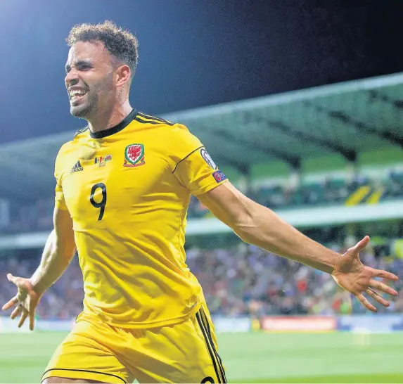  ??  ?? > Hal Robson-Kanu celebrates as Wales finally break the deadlock in Moldova last night