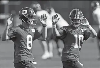  ?? ADAM HUNGER/AP PHOTO ?? In this May 20 file photo New York Giants quarterbac­ks Eli Manning (10) and Daniel Jones (8) warm up during practice at East Rutherford, N.J.