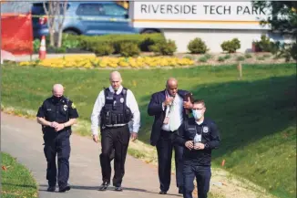  ?? Julio Cortez / Associated Press ?? Police walk near the scene of a shooting at a business park in Frederick, Md., on Tuesday.