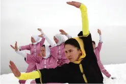  ??  ?? Shaolin martial arts students follow their trainer, Sima Azimi, 20, in black, during a practice session on a hilltop in Kabul.