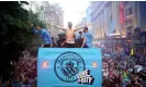  ?? City FC/Getty Images ?? Jack Grealish soaks up the adulation, and the rain, on the open-top bus parade during Manchester City’s treble celebratio­ns in June. Photograph: Lexy Ilsley/Manchester