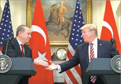  ?? KEVIN LAMARQUE / REUTERS ?? Turkey’s President Recep Tayyip Erdogan shakes hands with US President Donald Trump at the White House in Washington on Tuesday.