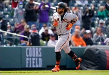  ?? AP Photo/David Zalubowski ?? San Francisco Giants’ Brandon Crawford circles the bases after hitting a tworun home run off Colorado Rockies starting pitcher Jon Gray in the second inning of a baseball game on Wednesday in Denver.