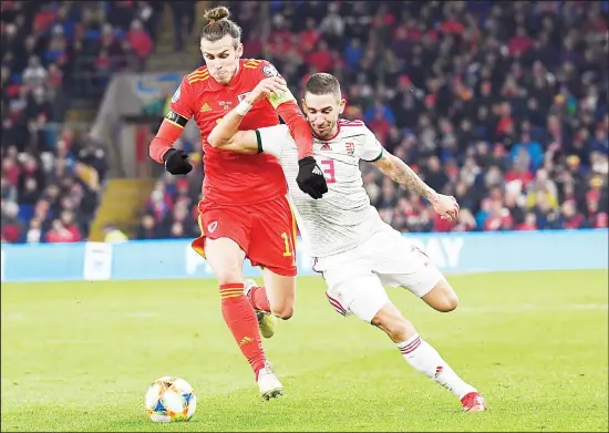  ??  ?? Zsolt Nagy (right), of Hungary and Gareth Bale of Wales in action during the Euro 2020 Group E qualifying soccer match between Wales and Hungary at Cardiff City Stadium in Cardiff,
Wales on Nov 19. (AP)