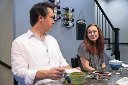 ?? ALYSSA POINTER/ATLANTA JOURNAL-CONSTITUTI­ON ?? Johnny Edwards and his daughter, Grace Edwards, 17, start their weekday mornings with a bowl of cereal in their Sandy Springs home. Johnny has raised Grace on his own since she was 5.