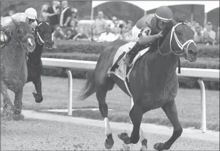  ?? The Sentinel-Record/Richard Rasmussen ?? REBEL WINNER: Jockey Luis Saez guides Magnum Moon across the wire to win the Grade 2 $900,000 Rebel Stakes for 3-year-olds at Oaklawn Park Saturday.