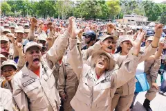  ?? RICARDO MAZALAN/ASSOCIATED PRESS ?? Venezuelan militia members shout slogans during a speech by their commander in Caracas on Friday. Military exercises were ordered after President Trump said he wouldn’t rule out a “military option” against Venezuela.