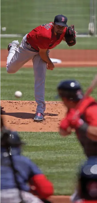  ?? STUART CAHiLL / HERALD STAFF ?? BACK IN RHYTHM: Nathan Eovaldi delivers a pitch during a workout Saturday at Fenway Park.