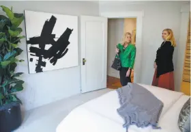  ?? Paul Chinn / The Chronicle ?? Real estate agent Mary Laughlin Fenton (left) tours a onebedroom, one-bath Pacific Heights condo on Gough Street listed by Marianne Schier in San Francisco.