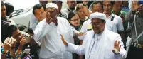  ?? (Darren Whiteside/Reuters) ?? HABIB RIZIEQ, leader of the Islamic Defenders Front, speaks to the media upon his arrival at Jakarta Police headquarte­rs yesterday.