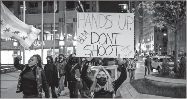  ?? Ap-ashlee Rezin Garcia ?? Protesters march down the Magnificen­t Mile after the city of Chicago released the videos of 13-year-old Adam Toledo being fatally shot by a Chicago police officer, Thursday evening in Chicago. Toledo was shot to death by an officer on March 29.