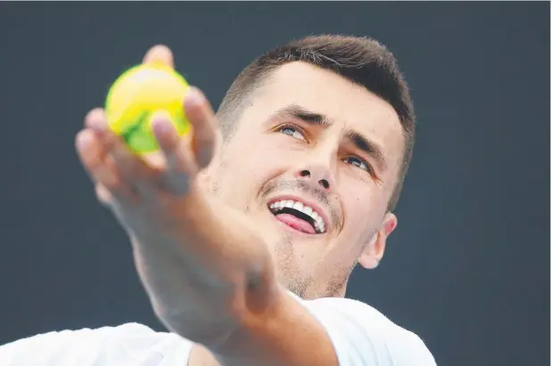  ?? Picture: GETTY IMAGES ?? DETERMINED: Bernard Tomic serves during a practice session ahead of the 2018 Australian Open. He’s unfazed at failing to get a wildcard for the event.