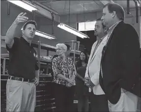  ??  ?? Georgia Northweste­rn Technical College automotive technology director Troy Peco (left) shows State Farm agent Mike Herndon (right) and state Rep. Jay Neal around the automotive labs on the Walker County campus.