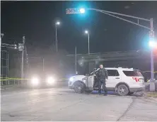  ?? ANDREW VAUGHAN, THE CANADIAN PRESS ?? A Halifax Regional Police officer leaves his vehicle at the scene of a shooting in Dartmouth, N.S., on Tuesday in which eight-year-old Lee-Marion Cain died.