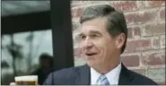  ?? ASSOCIATED PRESS FILE PHOTO ?? In this March 24 file photo, North Carolina Gov. Roy Cooper raises a toast at the NC Beer Month Proclamati­on, Tour & Reception at Rocky Mount Mills. The NCAA has awarded men’s basketball tournament games in 2020 and 2021 along with several other...