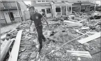  ?? AP PHOTO ?? Firefighte­r Austin Schlarb performs a door to door search in the aftermath of Hurricane Michael in Mexico Beach, Fla., Thursday.