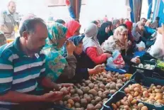  ??  ?? Egyptians buy low-priced potatoes at government-run outlets. Traders have hiked prices for the daily staple.