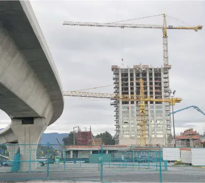  ?? JASON PAYNE FILE ?? The 11-kilometre-long Evergreen Line rapid transit project is 85 per cent complete, and is expected to be finished by February, 2017, about 21/2 years behind schedule. Pictured is commercial and residentia­l constructi­on next to the Burquitlam station.