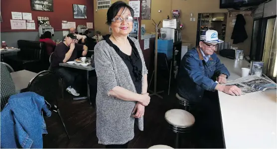  ?? Leah Hennel/Calgary Herald ?? Pam Fung is owner of the Lido Cafe, Kensington’s historic diner. The building is set to be torn down later this summer to make way for a new condo developmen­t.