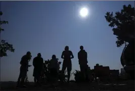  ?? TED S. WARREN — THE ASSOCIATED PRESS ?? People gather near Redmond, Ore., to view the sun as it nears a total eclipse by the moon on Aug. 21, 2017.