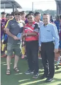  ??  ?? Dzulkarnai­n presenting a memento to Hockey Australia Country Tour Manager Michael Nelson while Madsarin (right) looks on.