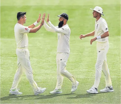  ?? Picture: Getty. ?? James Anderson celebrates with team-mate Moeen Ali after taking the wicket of Mitchell Starc of Australia during day four of the second Test.