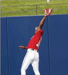  ?? JOHN BAZEMORE / ASSOCIATED PRESS ?? Washington Nationals outfielder Victor Robles makes a leaping catch to retire Tomas Nido of the Mets in a spring training game March 8.