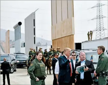  ?? MANDEL NGAN/GETTY-AFP ?? President Donald Trump inspects border wall prototypes in San Diego during his first visit to California as president.