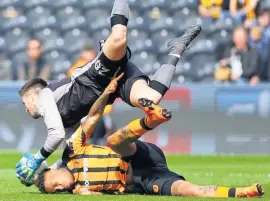  ??  ?? WILD THING Wednesday keeper Wildsmith flattens Hull strike star Hernandez