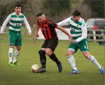  ??  ?? Dylan Vickers of Gorey Rangers on the ball as Sheriff duo Joe Flood and John Lester close in.