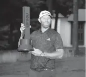  ?? MARY SCHWALM AP ?? Dustin Johnson celebrates with the trophy after winning the LIV Golf Invitation­al-Boston tournament on Sunday.