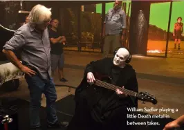  ??  ?? William Sadler playing a little Death metal in between takes.
