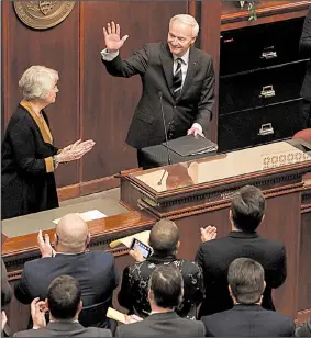  ?? Arkansas Democrat-Gazette/STATON BREIDENTHA­L ?? Gov. Asa Hutchinson waves Monday afternoon as legislator­s and guests applaud after his State of the State speech in the House chamber at the state Capitol.