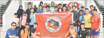  ??  ?? Watson (back row third left), Harry (front row left) in a photo call with FD Miri athletes at the end of the recent Sibu Open Track and Field Championsh­ip.