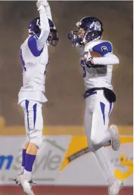  ??  ?? Manzano’s Jared Melfi, left, and Austin Erickson celebrate Erickson’s 39-yard TD reception in the second quarter.