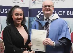  ??  ?? Rian English-Adams receiving her Dean’s List certificat­e from Dr Thomas O’Toole.