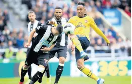  ?? AP ?? Arsenal’s Pierre-Emerick Aubameyang (right) and Newcastle United’s Javier Manquillo battle for the ball during their English Premier League match at St James’ Park in Newcastle, England, yesterday. Aubameyang scored the only goal in Arsenal’s 1-0 win.