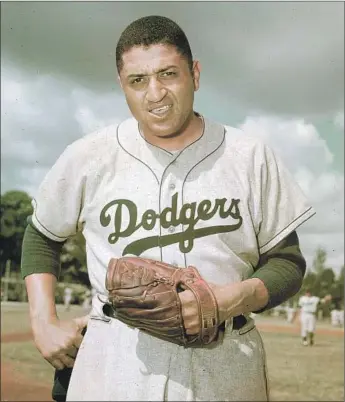  ?? Associated Press ?? DON NEWCOMBE HAS a look of determinat­ion during spring training in 1956, a season that turned out to be his best, with a 27-7 record earning him most valuable player and the first Cy Young Award.