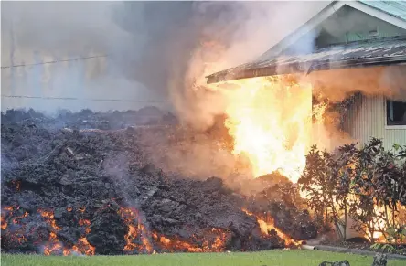  ??  ?? Flames started by lava consume a house Sunday morning near Pahoa, Hawaii. PHOTOS BY TREVOR HUGHES/USA TODAY