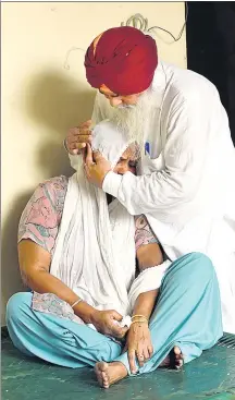  ??  ?? Attar Kaur, who lost her husband and 10 more members of her extended family in the riots, is consoled by a relative at her home in Delhi. SANCHIT KHANNA/HT