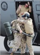  ??  ?? A Canadian soldier is given a hug as they arrive in Gao, Mali. Left: Chief of the Defence Staff General Jonathan Vance arrives with the first Canadian troops.