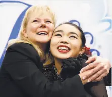  ?? Tony Avelar / Associated Press ?? Fremont’s Karen Chen (right) hugs coach Tammy Gambill as they view her scores during the women’s free-skate event.
