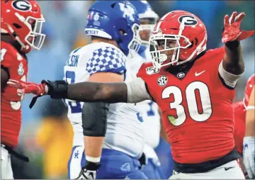  ?? Athens Banner-herald, via AP - Joshua L. Jones, file ?? Georgia linebacker Tae Crowder celebrates after bringing down Kentucky quarterbac­k Lynn Bowden Jr. during a game last season. Crowder was taken by the Giants with the 255th and final pick of the NFL draft, earning the ceremonial title of Mr. Irrelevant.